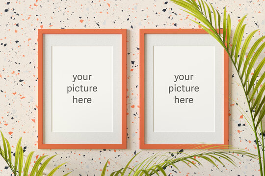 Three dimensional render of two picture frames with placeholder text hanging on terrazzo wall