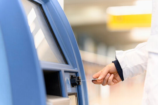 Man's hand withdrawing money at ATM machine
