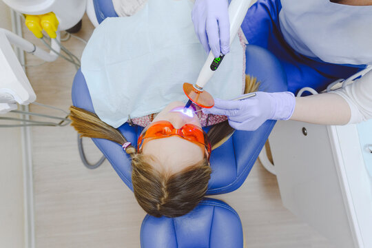 Little girl lying in dentists chair during dental exam