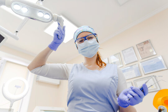 Portrait of female dentist wearing protective face mask working at office