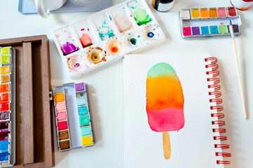 Colorful popsicle painted with watercolors on spiral notebook