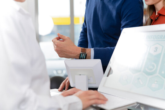 Male customer paying with smart watch at pharmacy checkout