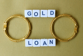 Gold loan concept depiction through jewelry, plastic blocks and written words