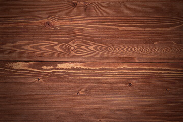 Naklejka premium Dark wooden table or tabletop as texture or background. Top view of an empty wooden desk texture.