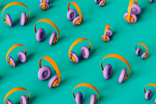 Small and large multi colored headphones on green background