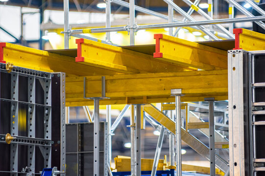 Yellow metal beams on scaffolding props