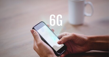 Composition of 6g text over woman holding smartphone in background