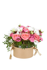 bouquet of flowers of pink roses in a round box of brown color on a white isolated background