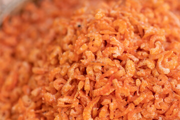 Close-up of dried shrimp, stacked on a tray and blurred the background.