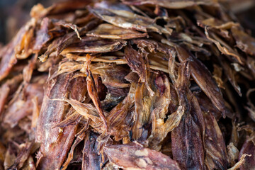 Dried Beka Squid one of the dried seafood dishes, lined on a tray.