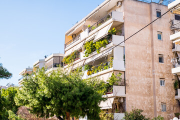 beautiful streets of Athens with blocks of flats, cars and shops