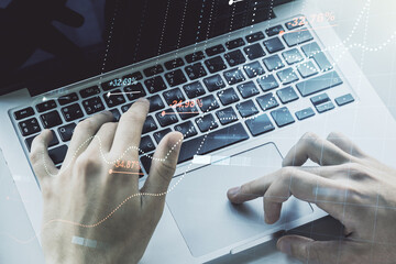 Multi exposure of abstract statistics data hologram interface with hands typing on computer keyboard on background, computing and analytics concept