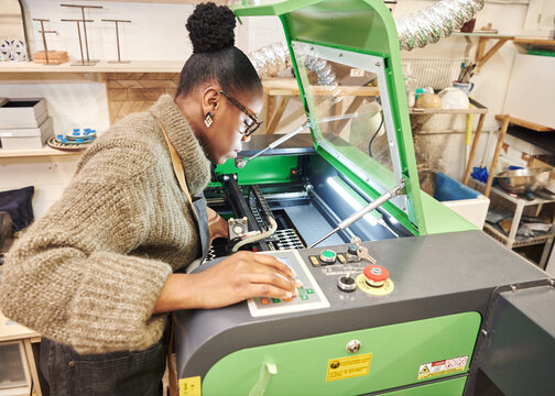 person operating a laser cutting machine