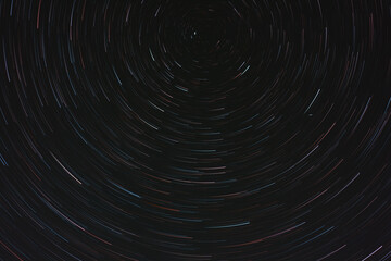 Circumpolar star trails in night sky