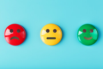 Emotional satisfaction survey icons are Red yellow green on a blue background