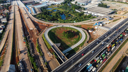 Fototapeta na wymiar Aerial view on the new road construction site at Bekasi. Bekasi, Indonesia, April 26, 2021