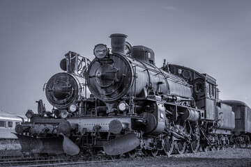 Two old steam locomotives standing side by side