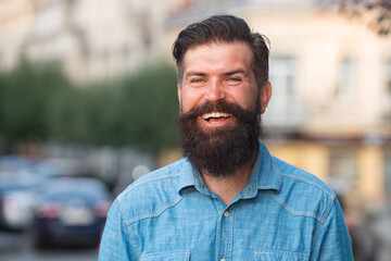 Obraz premium Young handsome bearded hipster man in the city.