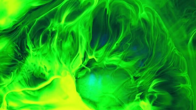 Deep green and yellow inks interact with each other to create abstract shapes, swirls, and splash. Screensaver for advertising or background display colors. Deep ink space.