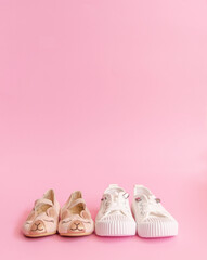 Pink and white shoes isolated in pink background 