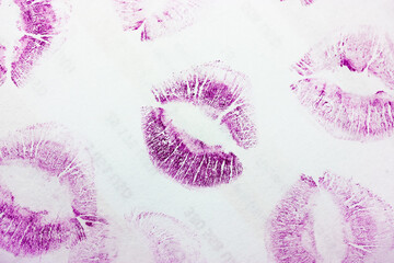 Abstract purple kisses isolated on white background. Lots of female lip prints on paper. Beautiful neon lips stamps. Valentine's day, romantic mood and love concept. Lipstick kisses. Print of lips