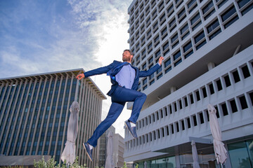 Businessman running, jumping. Concept of fast business with running business man. To stay on top.