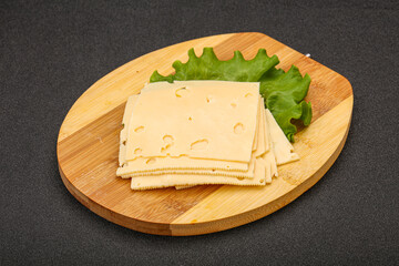 Sliced yellow cheese over board