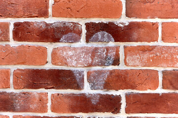Red brick wall with heart pattern in white paint straight