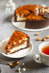 Delicious tart. Tasty and beautiful dessert - salted caramel cheesecake with chocolate and nuts made by chef