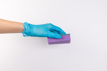 Sponge for washing dishes in female hand. Hand in a latex glove. Woman's hand gesture or sign isolated on white. A hand in a glove holds a sponge for washing and cleaning dishes