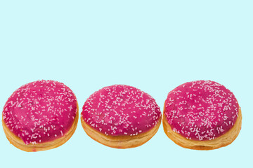 View of pink  donuts sprinkled with white glaze isolated on blue background. Food and drink concept.