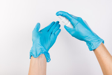 Health protection equipment such as gloves and sanitizer held in hands, isolated on white background