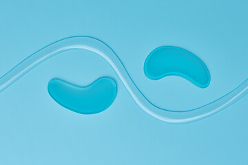 Hydrogel patches for the eyes. Blue under eye patches with collagen on blue background. The concept...