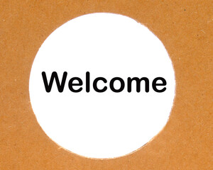 welcome text on a round cardboard hole