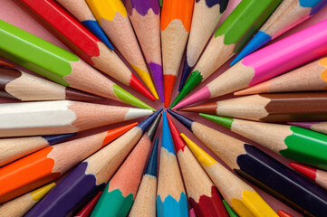 Naklejka premium A set of colored pencils. Laid out in a circle, background from pencils 