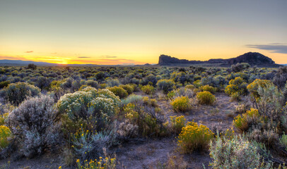 The sun sets behind Fort Rock in Oregon