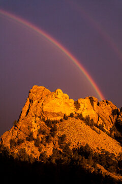A double rainbow arches over the presidents of Mount Rushmore, South Dakota.