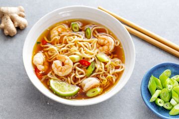 Asian noodles in bowl on concrete background