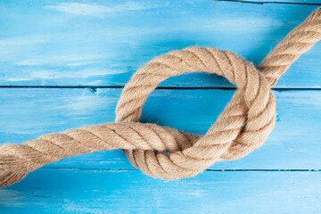 thick rope woven into a knot on a blue background