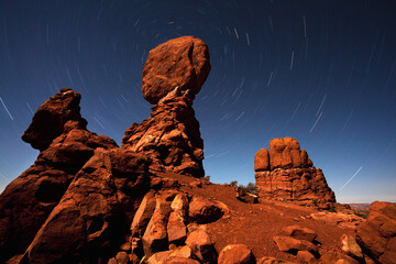 Balanced Rock and star trails during a near full moon at Arches National Park.