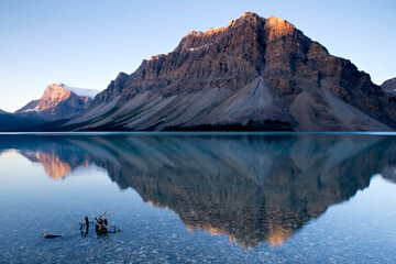 Perfectly calm water made for an ideal mountain reflection during this sunrise at Bow Lake in Banff National Park, Alberta, Canada