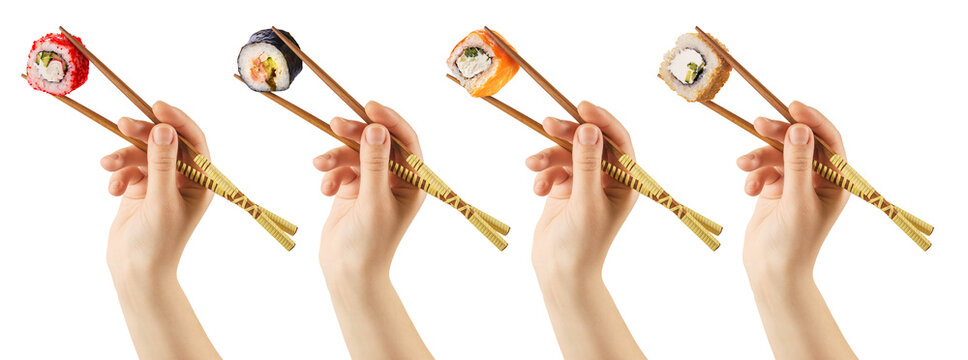 Women's hands hold sushi rolls with sticks. White background. Creative concept. Clipping path.
