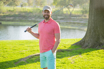 Smiling golfer man in cap playing golf.