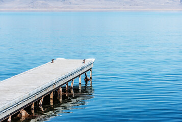 A wooden pier reaches out into Pyramid Lake, Great Basin in the northwestern part of Nevada, USA