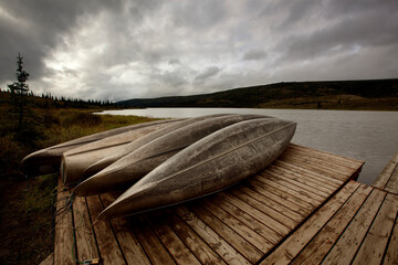 Canoes rest on the dock of Wonder Lake as a morning storm approaches.