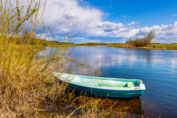 Early spring panoramic view of Biebrza river valley wetlands and nature reserve landscape with vintage canoe in Burzyn village in Podlaskie voivodship in Poland