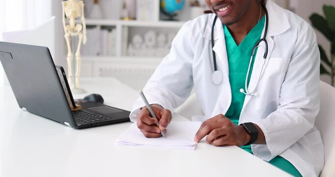 young african american doctor filling paper documentation