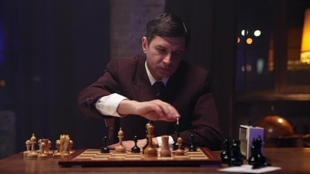 Two chess players man and woman play chess. Debut Accepted Queen's Gambit, King's Gambit, Philidor's Defense. Cinematic filming of a chess game. Antique chess board. This shot can be used for films.