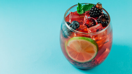 blackberry cocktail with ice, lemon and mint leaf