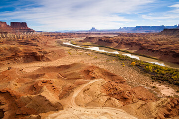 The rugged canyons of Canyonlands National Park extend in all directions as seen from The White Rim Trail above the Green River near Moab, Utah. The canyons have been cut over eons by water, wind and the elements creating a rugged landscape that are a playground for adventurers and hideaways for outlaws.
